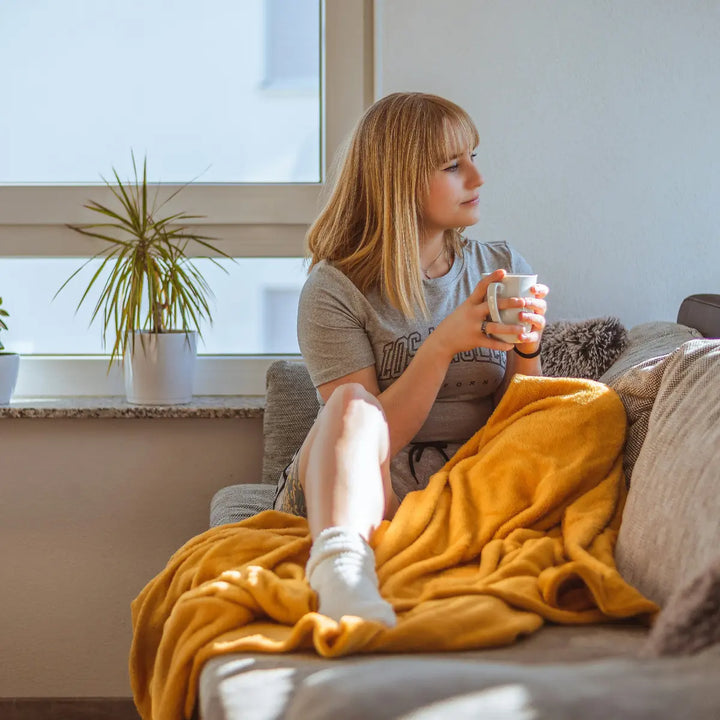 Woman holding a cup at home, illustrating recovery of everyday arm and hand function after stroke